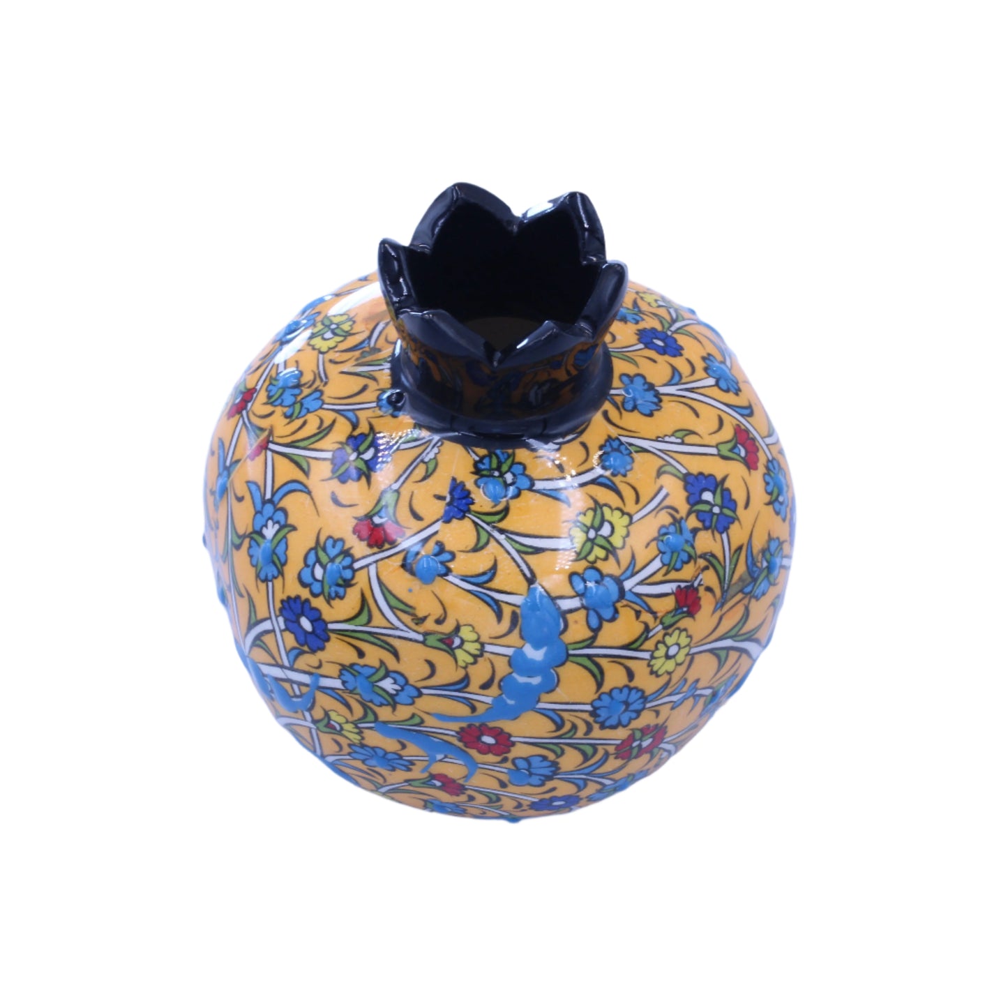 Decorative ceramic pomegranate with floral patterns on a light blue background