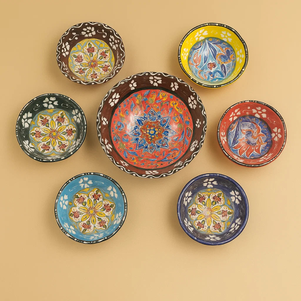 Set of colorful ceramic bowls with floral patterns on a beige background