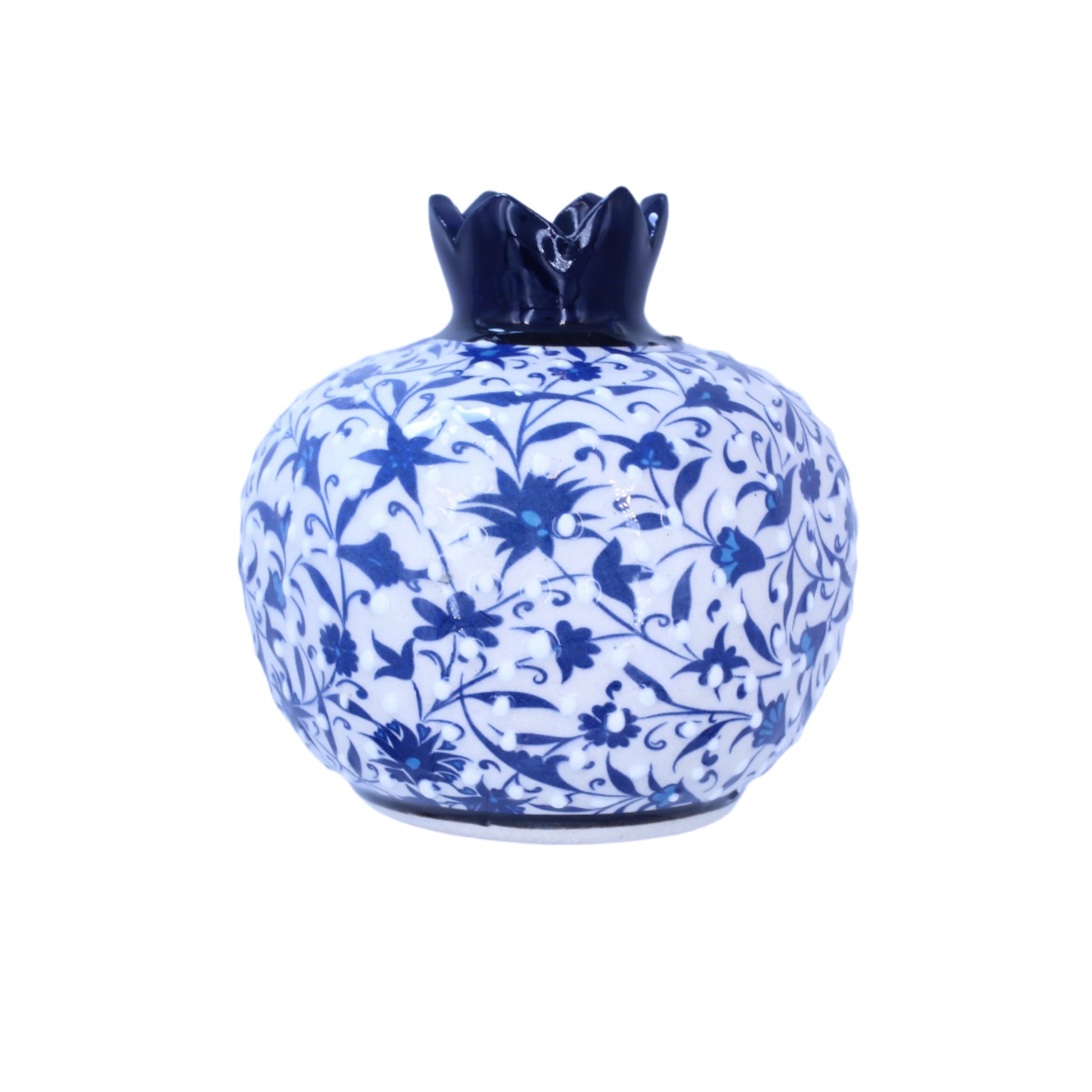 Decorative ceramic pomegranatewith blue floral patterns on a light purple background