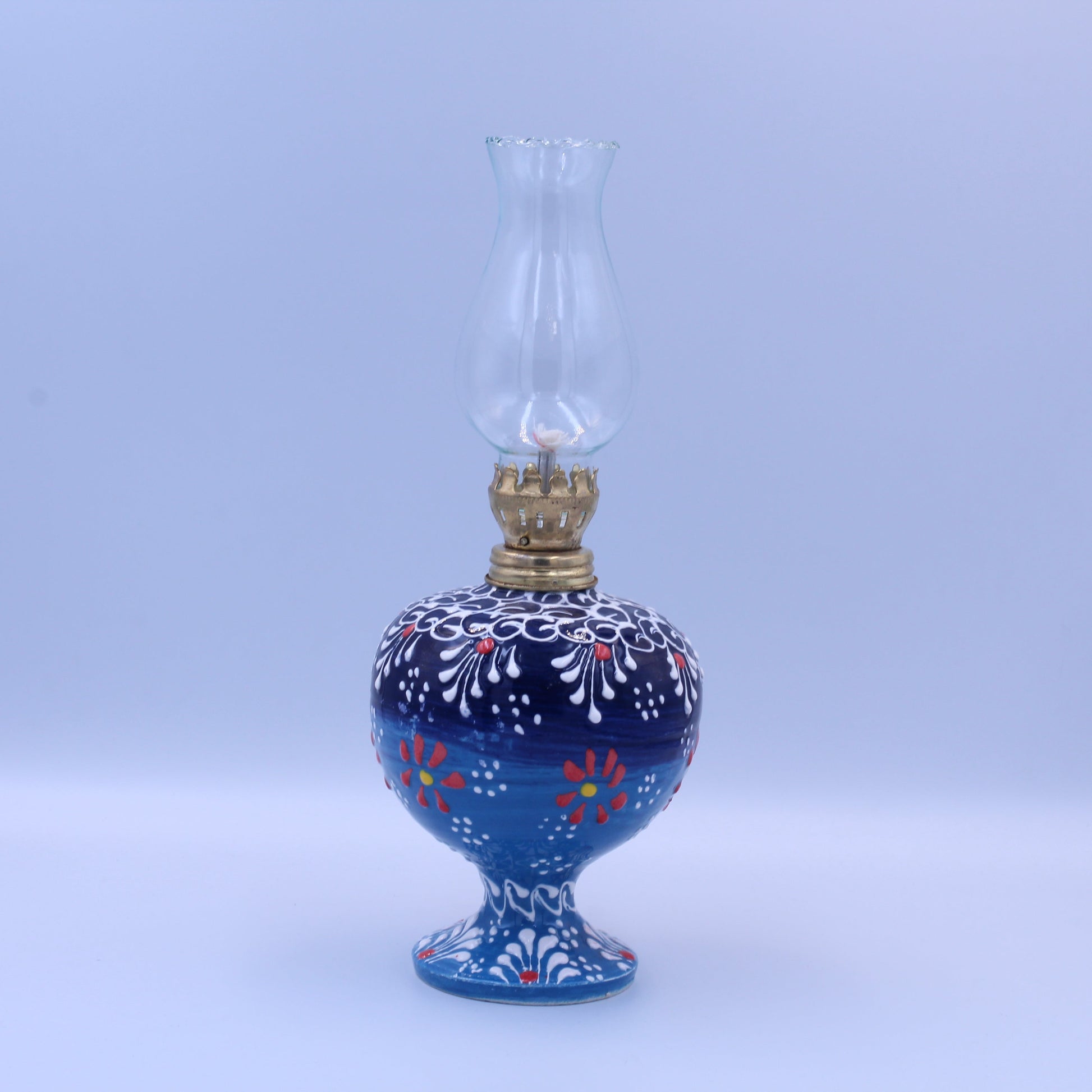 Blue oil lamp with floral patterns on a white background